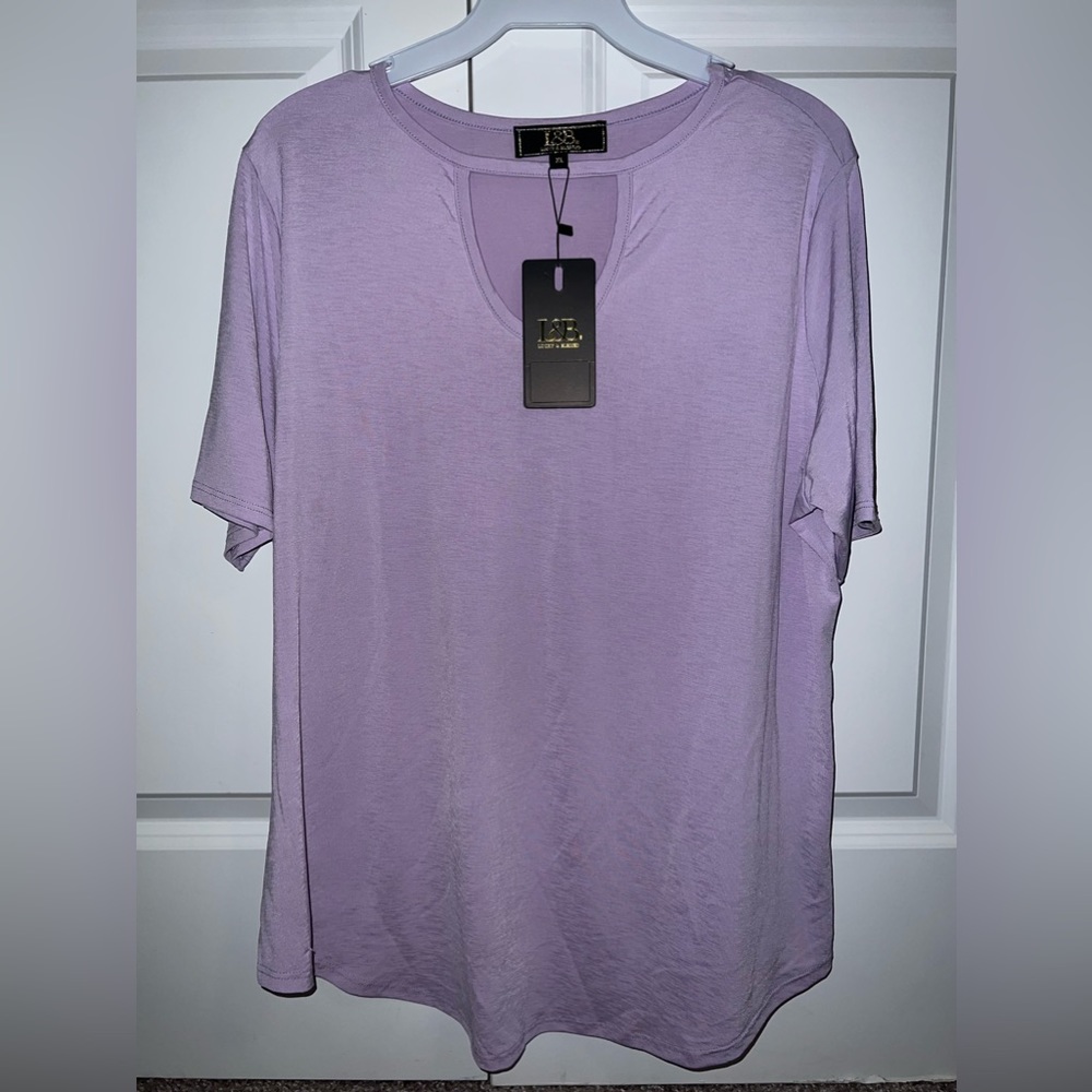 New in packaging,Women’s violet blouse. Sizes xl-3xl